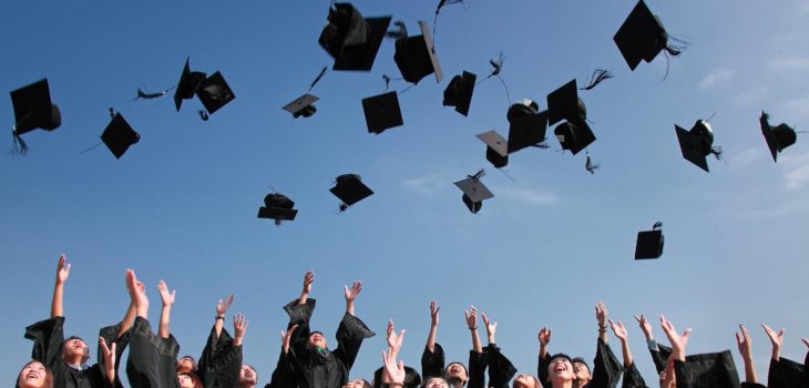 Graduates tossing black caps into the air LAUNCH Flagstaff