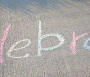 Celebrate! written on a sidewalk in chalk
