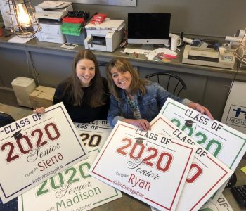 Print shop owners display class of 2020 graduate signs