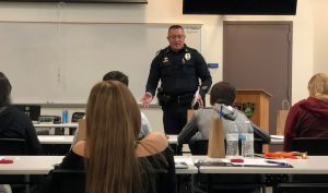 Sargent Charles Hernandez of the Flagstaff Police Department speaks with a group of high school students