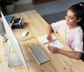 girl looking at computer learning from home